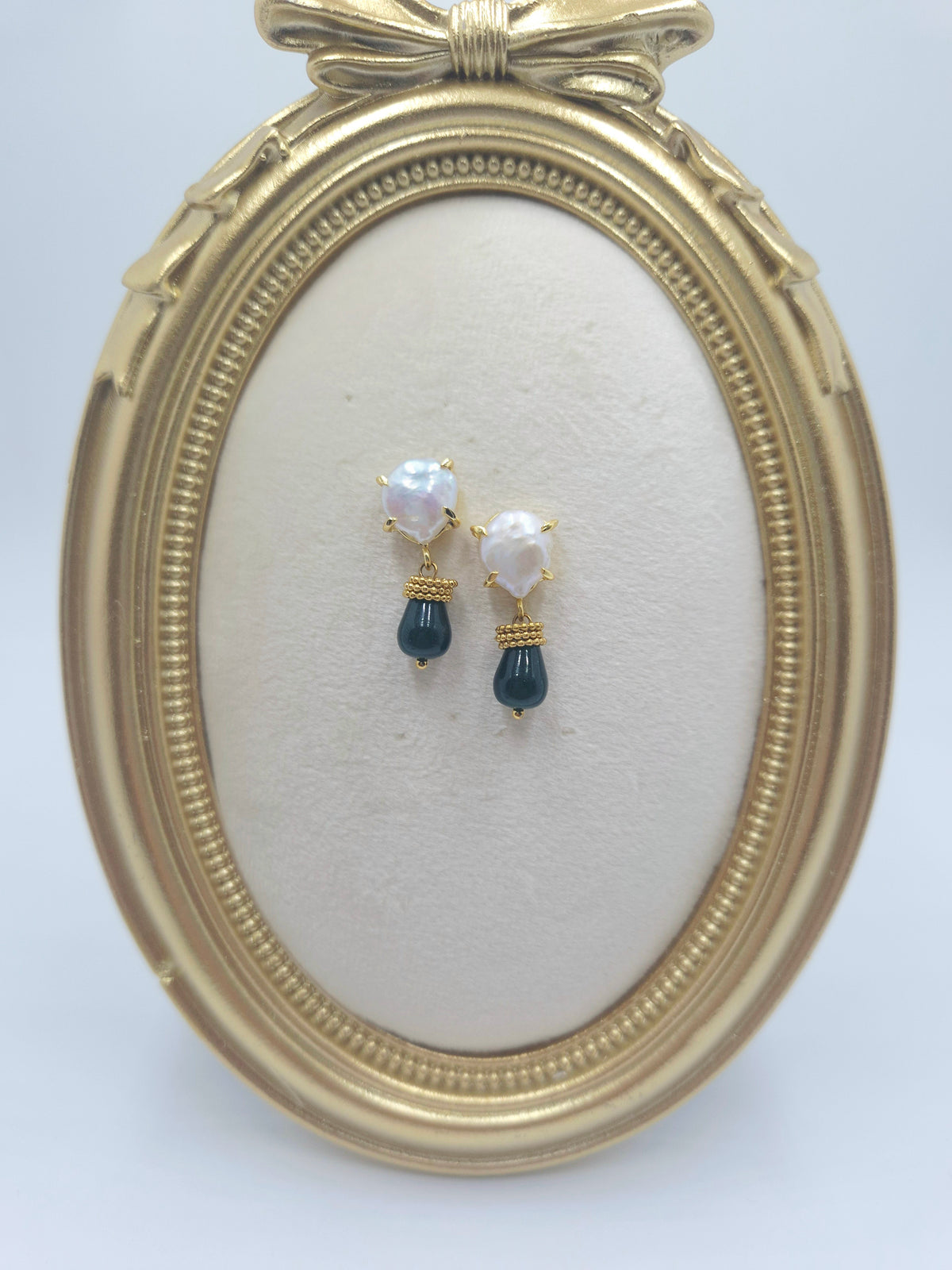Pearl cushion studs with deep sea green-blue stone drops and gold-tone rings