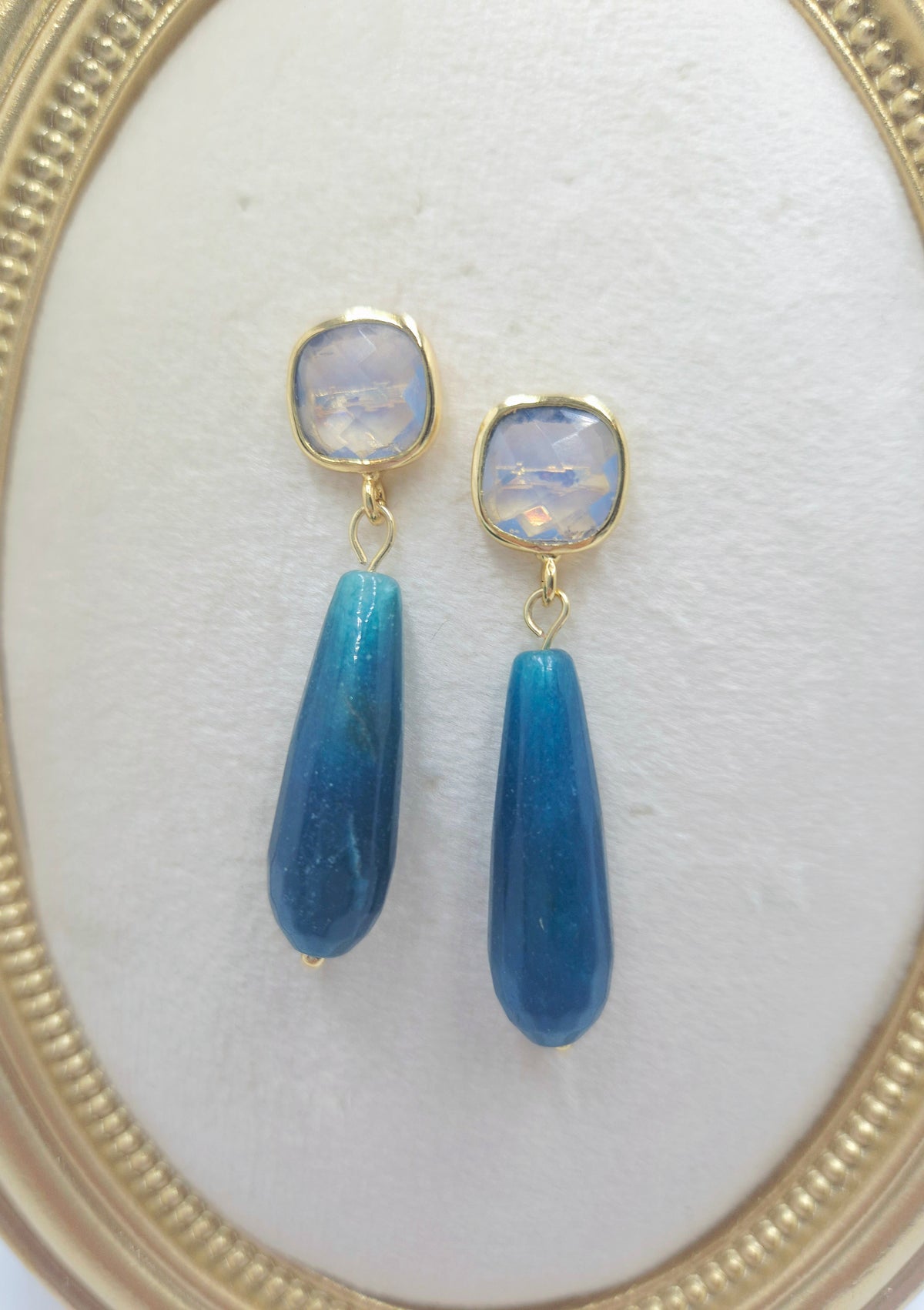 Close-up of opalite cushion studs and blue angelite drops