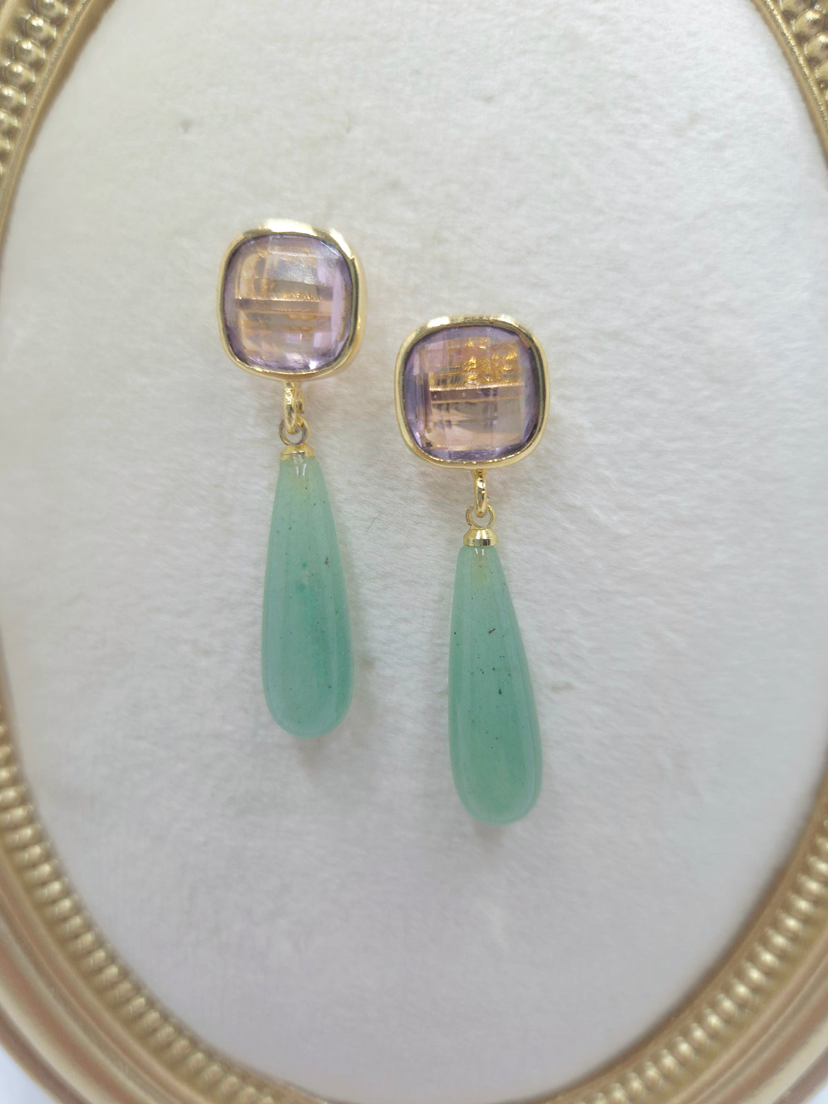 Close-up of gold-plated pink quartz cushion studs and green aventurine drops