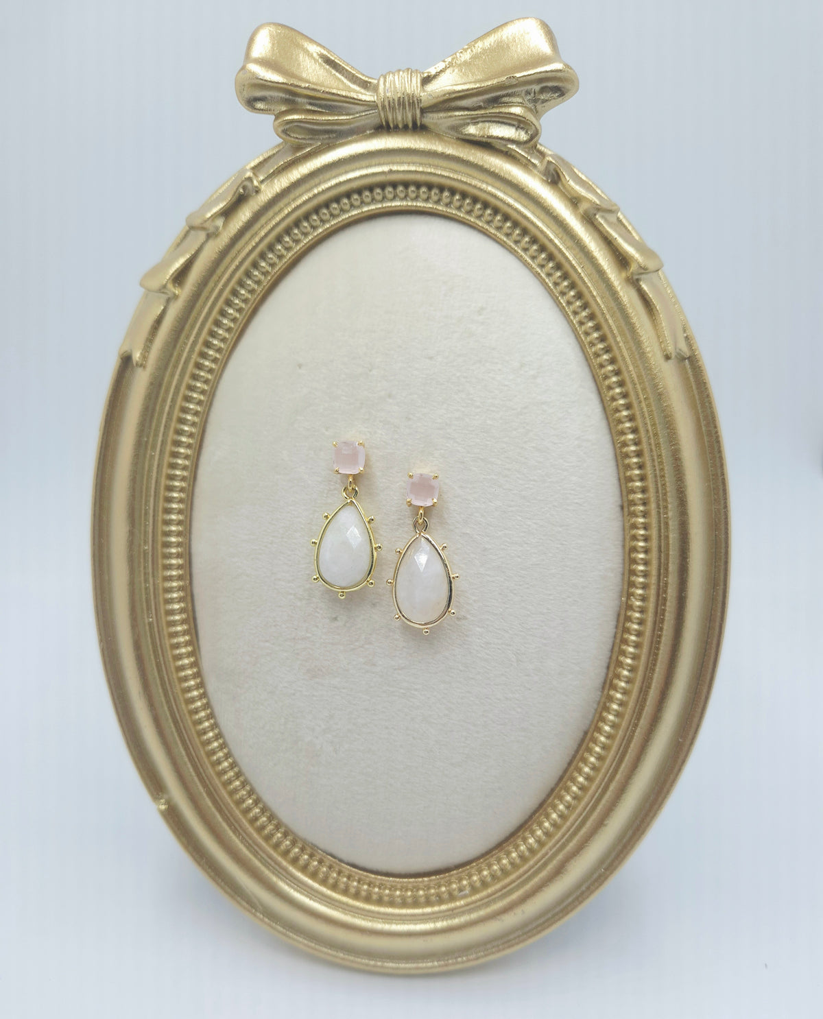 Full view of pink chalcedony and white crystal drop earrings